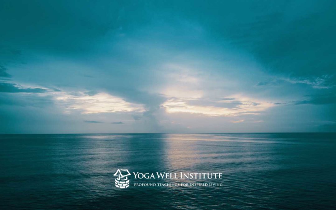 Blue ocean background with Yoga Well Institute's logo below